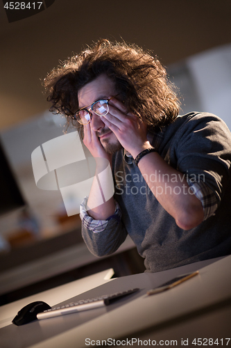 Image of businessman relaxing at the desk