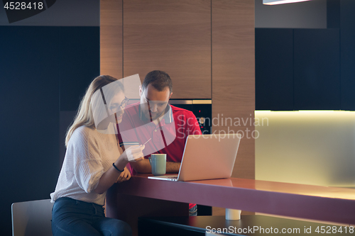 Image of happy young couple buying online