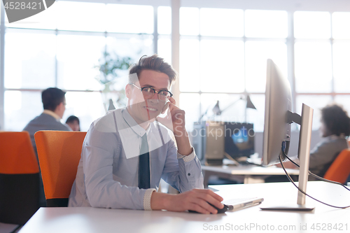 Image of businessman working using a computer in startup office