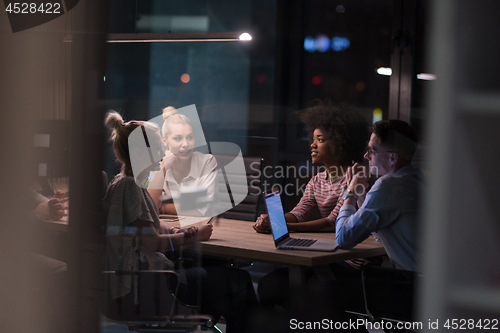 Image of Multiethnic startup business team in night office