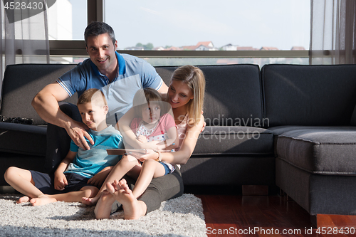 Image of happy young couple spending time with kids
