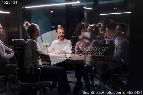 Image of Multiethnic startup business team in night office