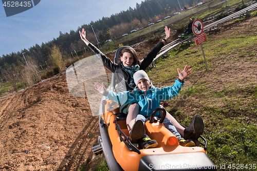 Image of mother and son enjoys driving on alpine coaster