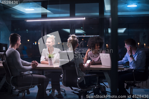 Image of Multiethnic startup business team in night office