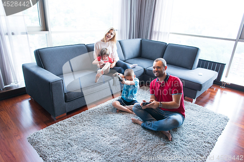 Image of Happy family playing a video game