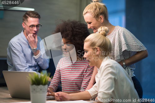 Image of Multiethnic startup business team in night office