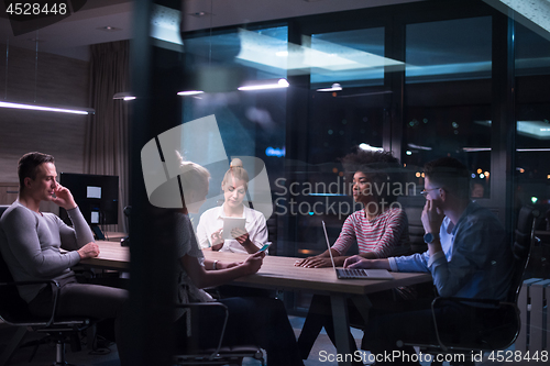 Image of Multiethnic startup business team in night office