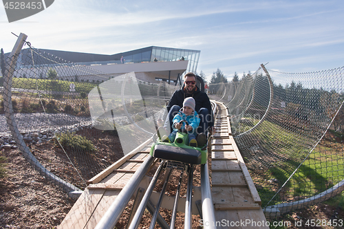 Image of father and son enjoys driving on alpine coaster