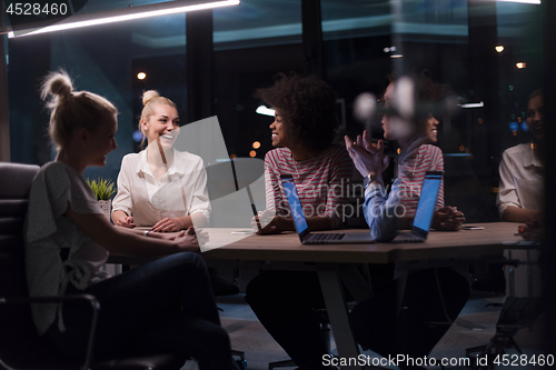 Image of Multiethnic startup business team in night office