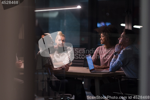 Image of Multiethnic startup business team in night office