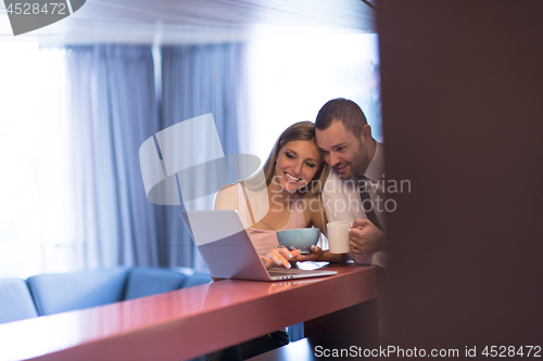 Image of A young couple is preparing for a job and using a laptop