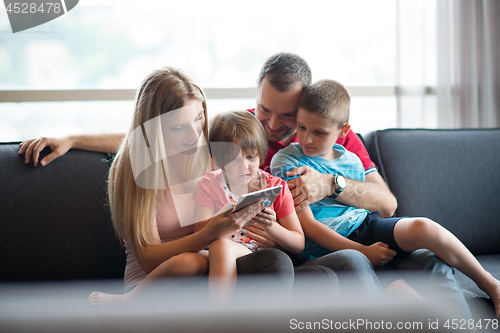 Image of happy young couple spending time with kids