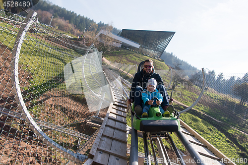 Image of father and son enjoys driving on alpine coaster