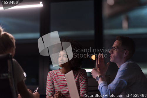 Image of Multiethnic startup business team in night office