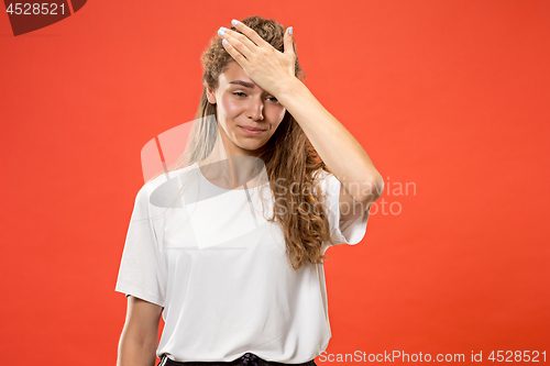 Image of Woman having headache. Isolated over pastel background.