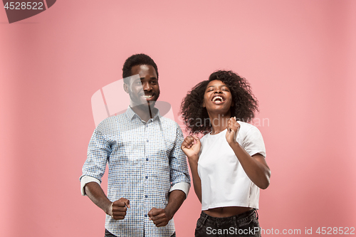 Image of Winning success woman happy ecstatic celebrating being a winner. Dynamic energetic image of female afro model