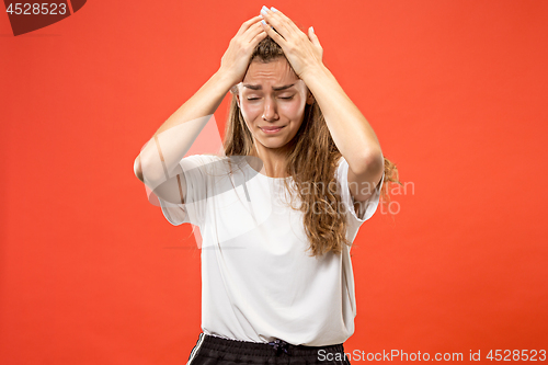 Image of Woman having headache. Isolated over pastel background.
