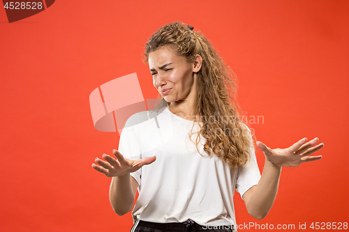 Image of Let me think. Doubtful pensive woman with thoughtful expression making choice against pink background