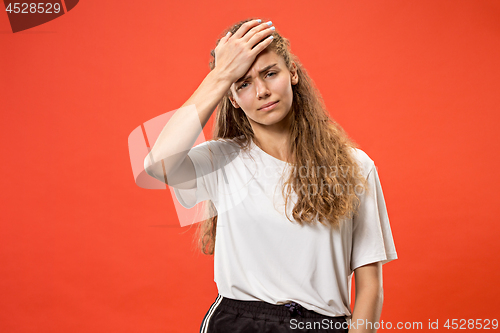 Image of Woman having headache. Isolated over pastel background.