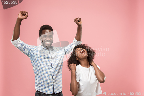 Image of Winning success woman happy ecstatic celebrating being a winner. Dynamic energetic image of female afro model