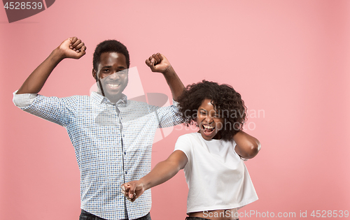 Image of Winning success woman happy ecstatic celebrating being a winner. Dynamic energetic image of female afro model