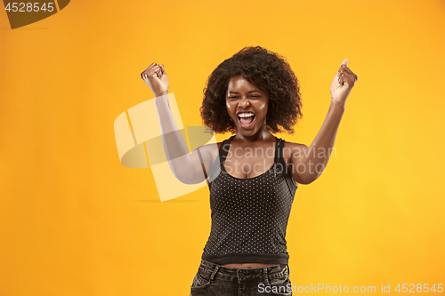 Image of Winning success woman happy ecstatic celebrating being a winner. Dynamic energetic image of female afro model