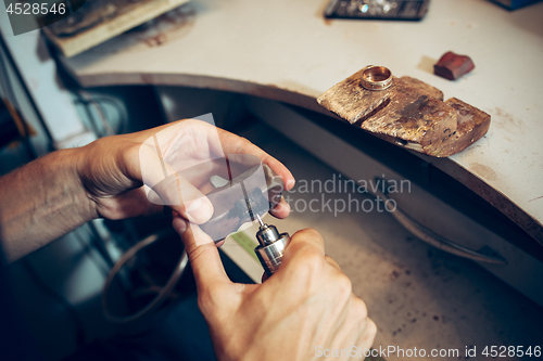 Image of Different goldsmiths tools on the jewelry workplace. Jeweler at work in jewelry.