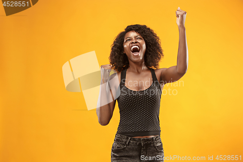 Image of Winning success woman happy ecstatic celebrating being a winner. Dynamic energetic image of female afro model