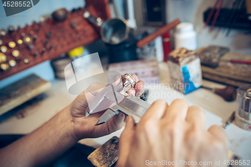 Image of Different goldsmiths tools on the jewelry workplace. Jeweler at work in jewelry.