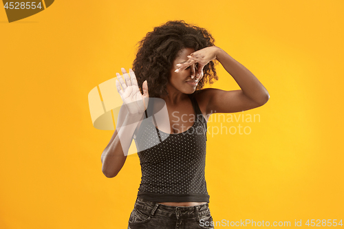 Image of Let me think. Doubtful pensive woman with thoughtful expression making choice against yellow background
