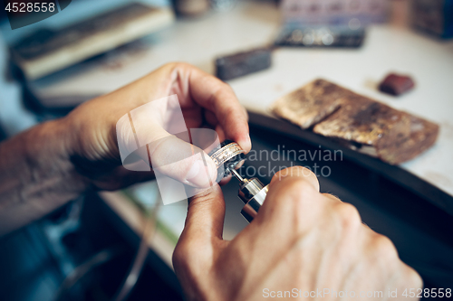 Image of Different goldsmiths tools on the jewelry workplace. Jeweler at work in jewelry.