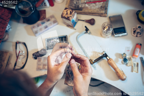 Image of Different goldsmiths tools on the jewelry workplace. Jeweler at work in jewelry.