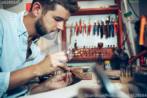 Image of Different goldsmiths tools on the jewelry workplace. Jeweler at work in jewelry.