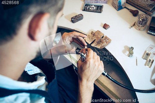 Image of Different goldsmiths tools on the jewelry workplace. Jeweler at work in jewelry.