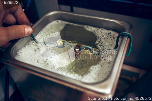 Image of Different goldsmiths tools on the jewelry workplace. Jeweler at work in jewelry.