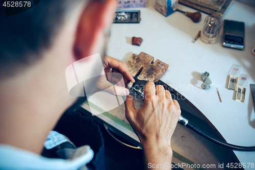 Image of Different goldsmiths tools on the jewelry workplace. Jeweler at work in jewelry.