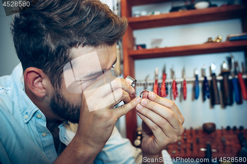 Image of Different goldsmiths tools on the jewelry workplace. Jeweler at work in jewelry.