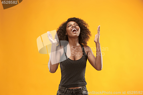 Image of Winning success woman happy ecstatic celebrating being a winner. Dynamic energetic image of female afro model