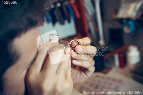 Image of Different goldsmiths tools on the jewelry workplace. Jeweler at work in jewelry.