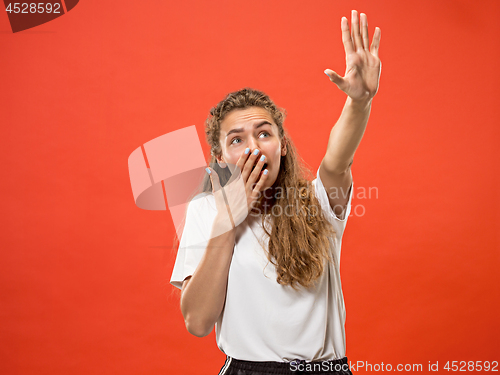 Image of Portrait of the scared woman on red