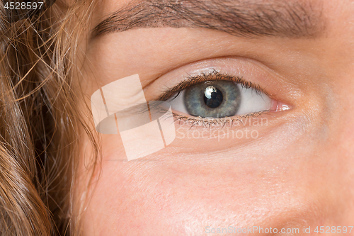 Image of The close up eye on face of young beautiful caucasian girl