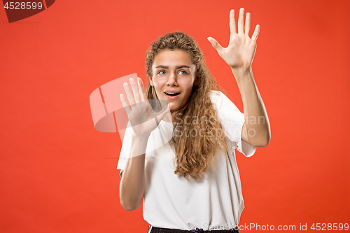 Image of Portrait of the scared woman on red