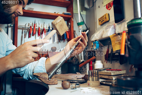 Image of Different goldsmiths tools on the jewelry workplace. Jeweler at work in jewelry.