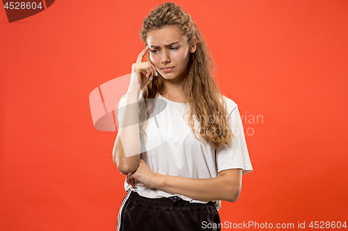 Image of Young serious thoughtful woman. Doubt concept.