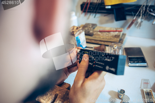 Image of Different goldsmiths tools on the jewelry workplace. Jeweler at work in jewelry.