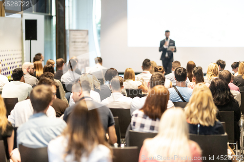 Image of Male business speaker giving a talk at business conference event.