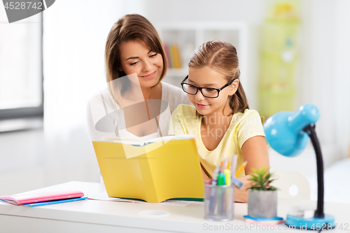 Image of mother and daughter doing homework together