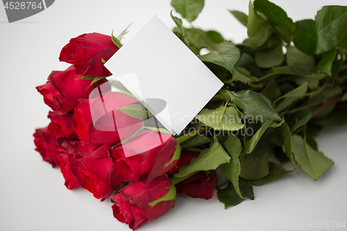 Image of close up of red roses and letter or note