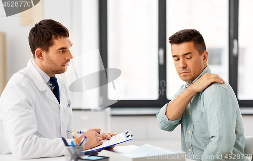 Image of patient showing sore shoulder to doctor at clinic