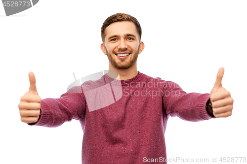 Image of happy young man showing thumbs up